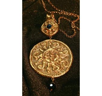 large medallion with golden sun